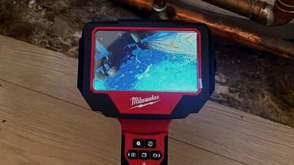Borescope inspection camera used to trace a leak behind a hot water cylinder