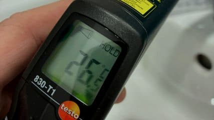 Testo 830-T1 infrared thermometer showing a 26.5 degree reading at a basin